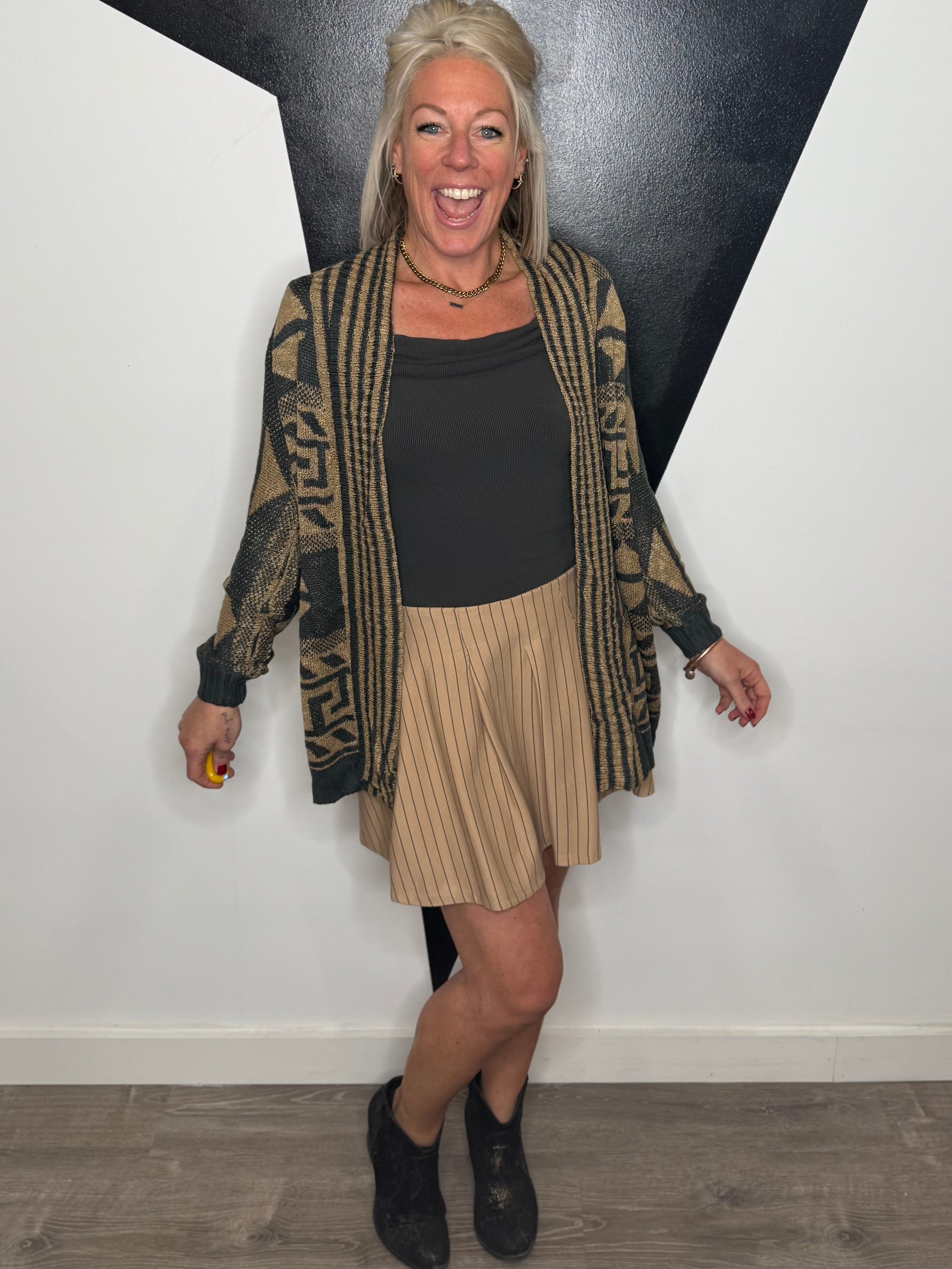 Woman posing against a black and white wall