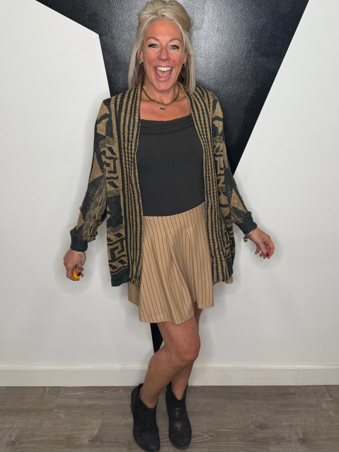 Woman posing against a black and white wall