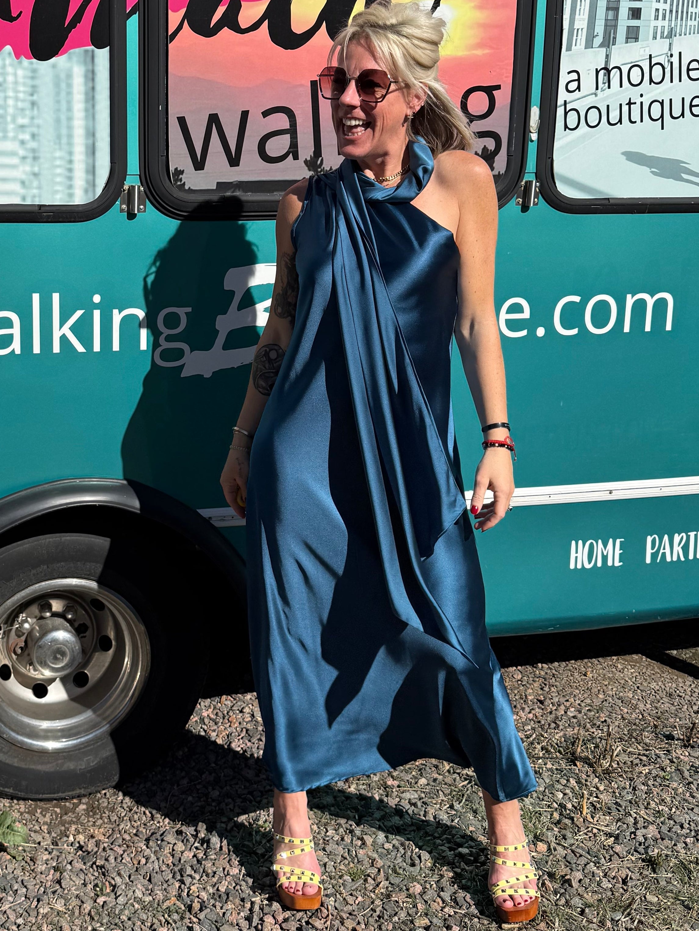 Person standing on a street with a bus in the background