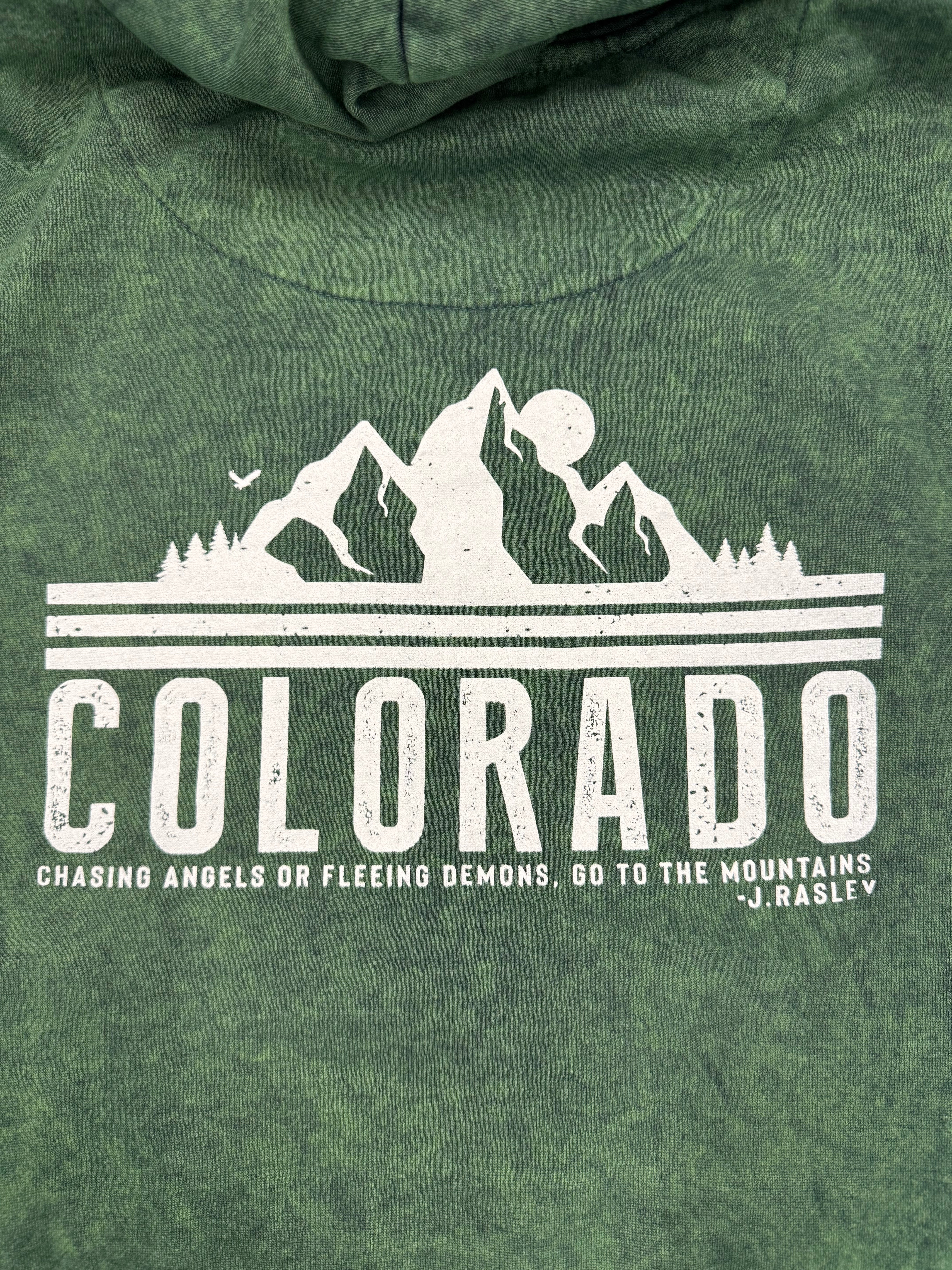 Green mineral wash hoodie with white graphic and text on a green background