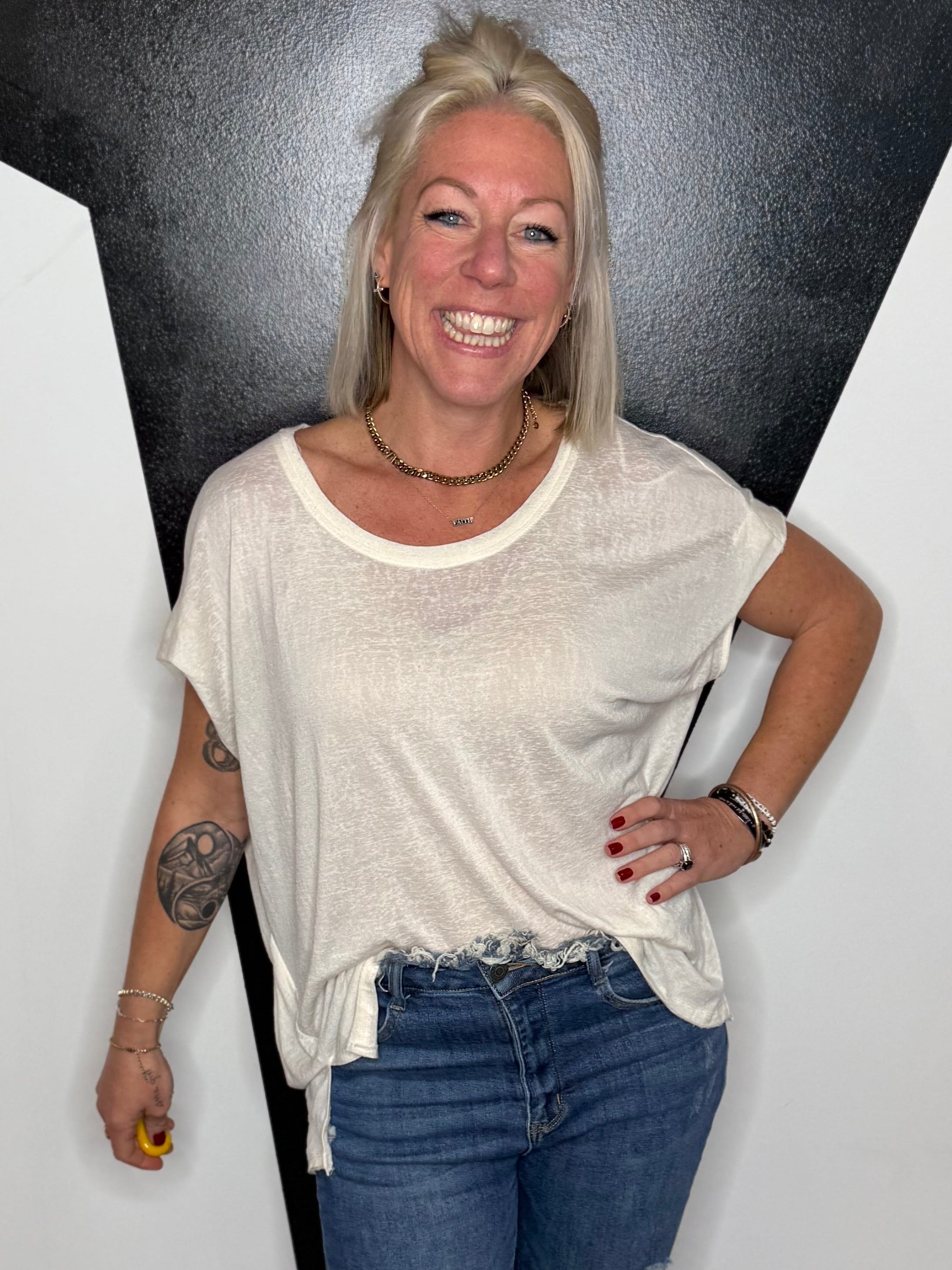 Person standing in front of a black and white geometric wall design