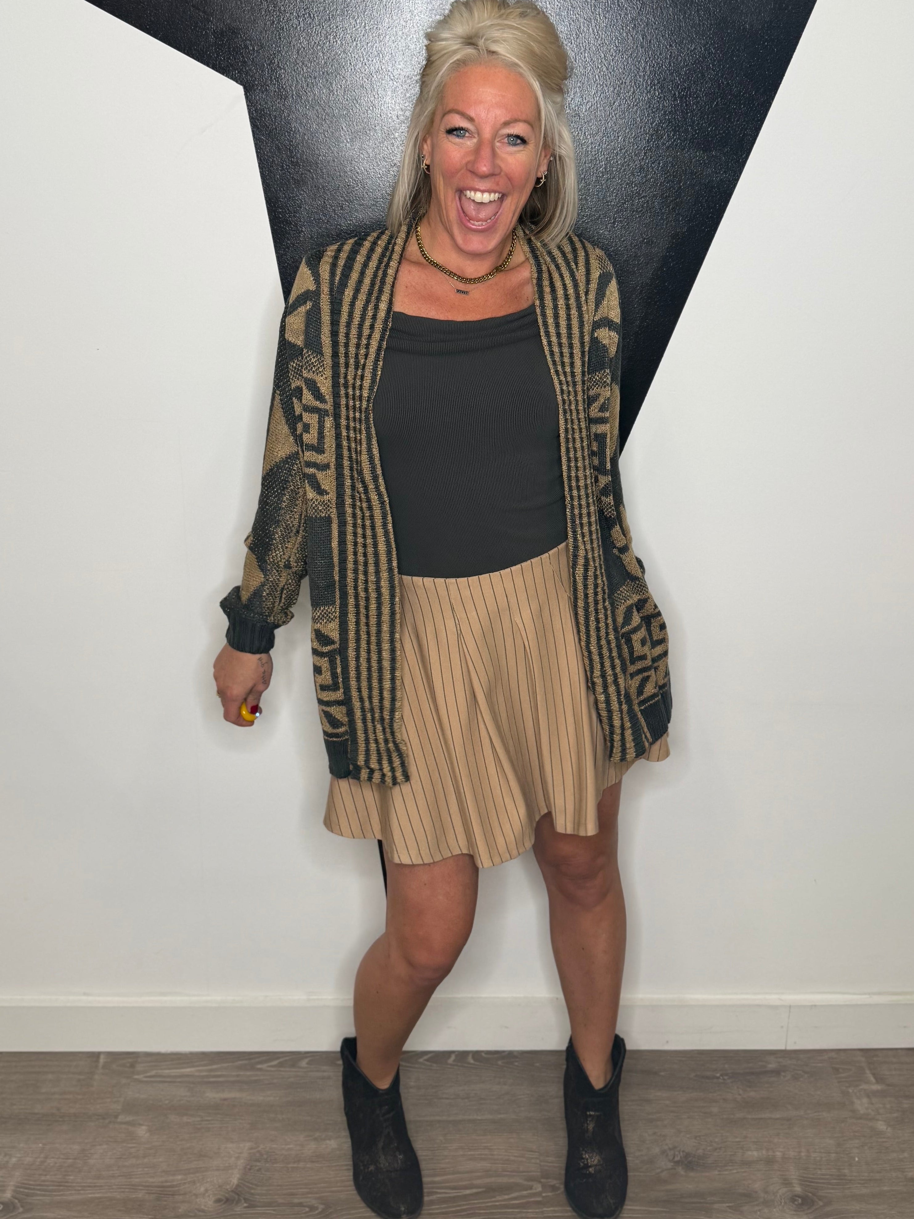 Woman standing in front of a black and white geometric wall art piece.