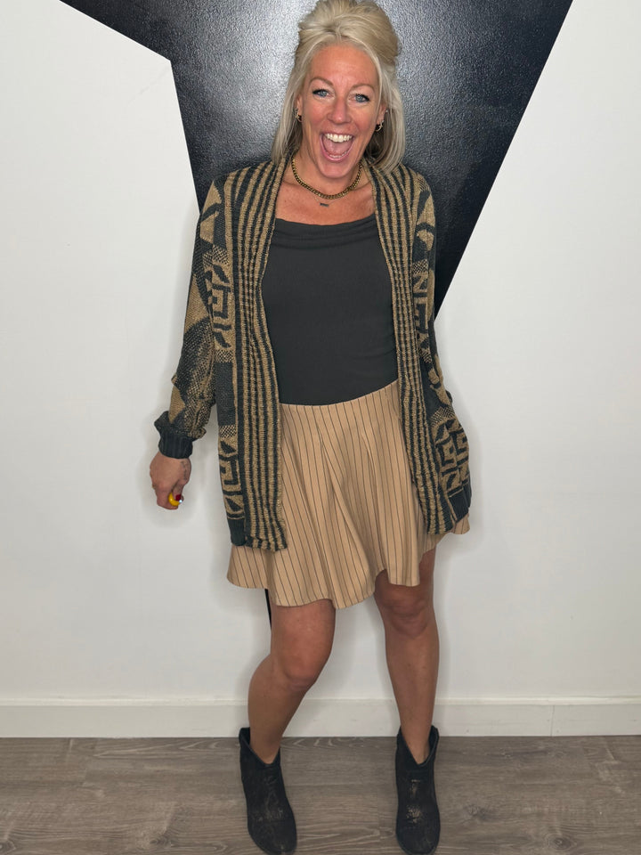 Woman standing in front of a black and white geometric wall art piece.