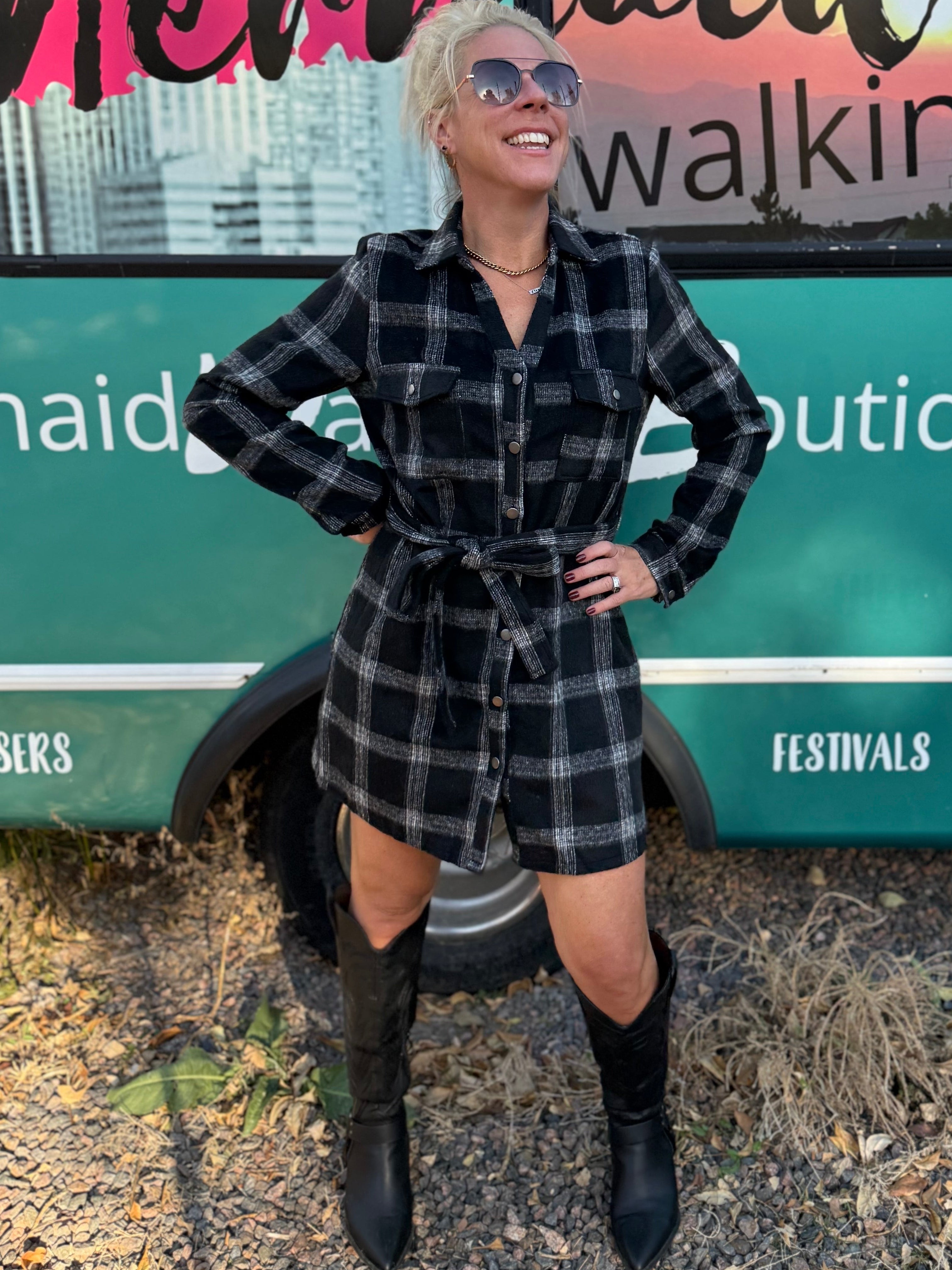 Woman posing in front of a 'Mermaid Walking' mobile boutique truck.