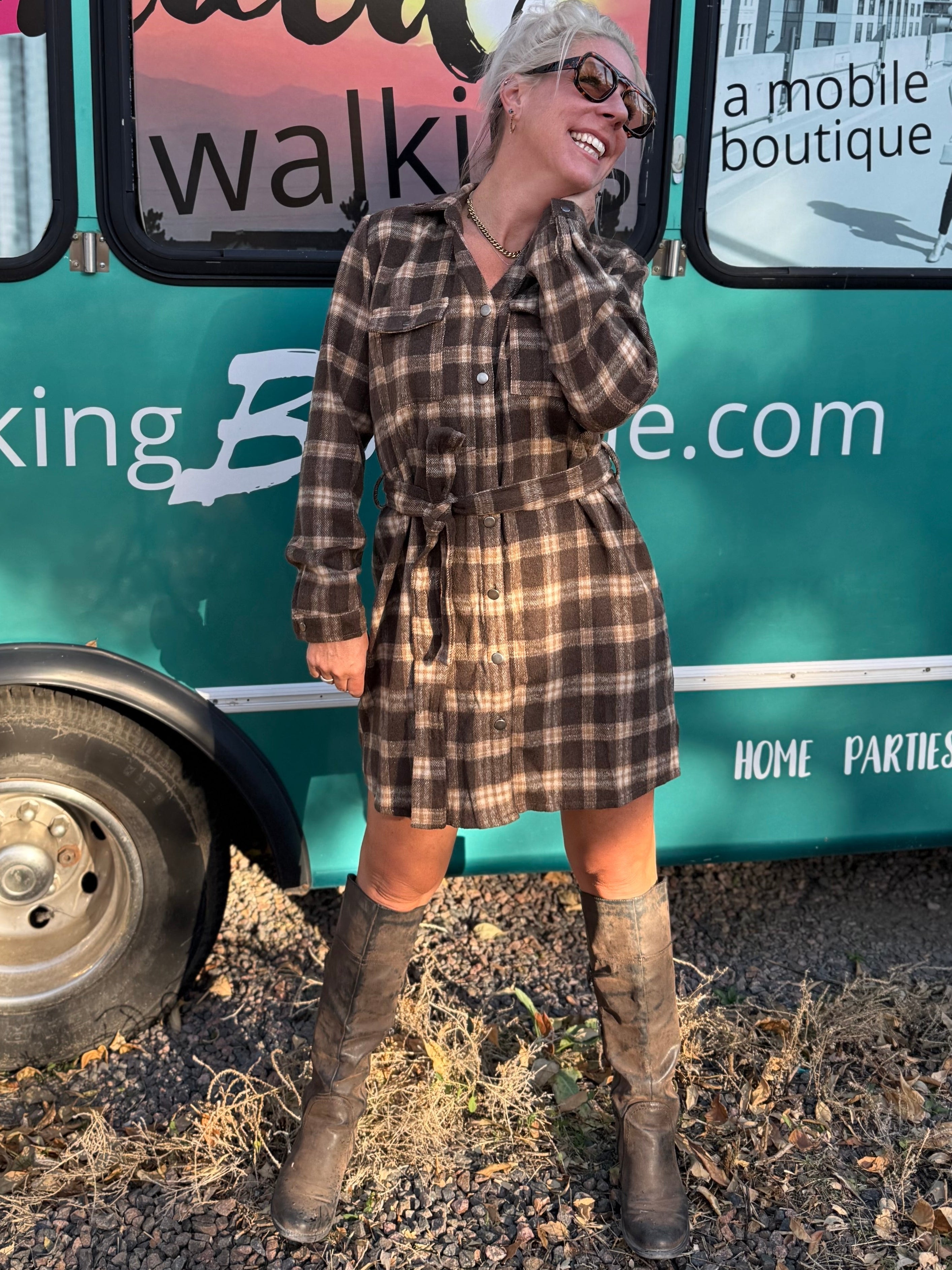 Woman standing in front of a mobile boutique trailer with 'Everyaid Walking' branding.