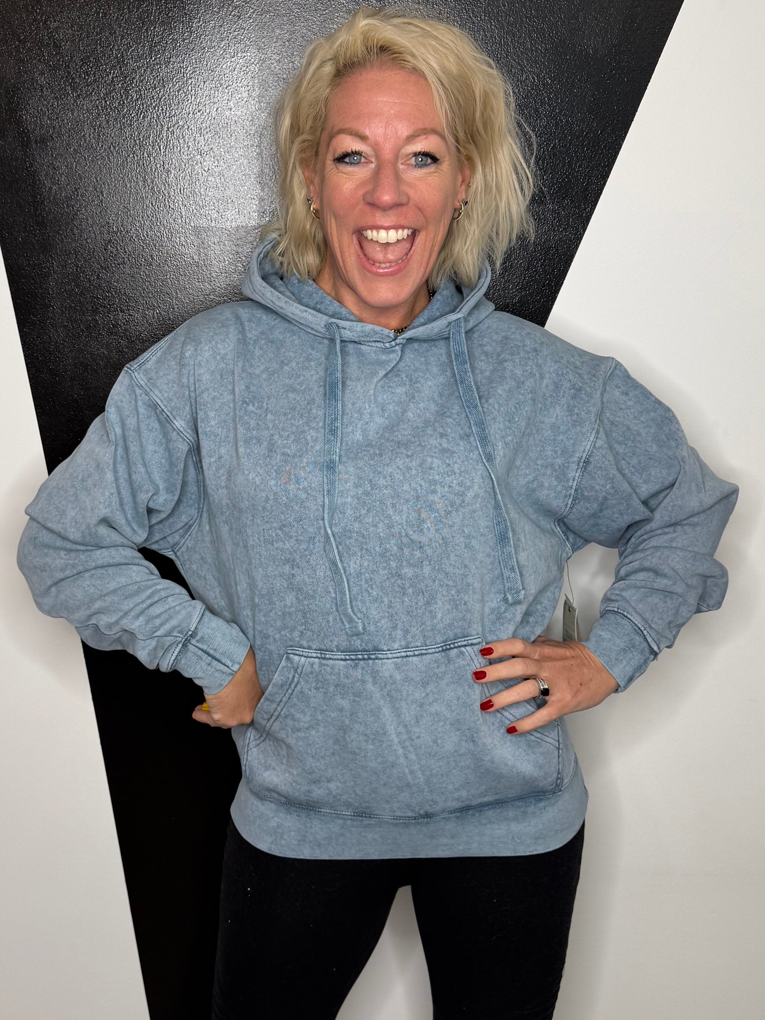 Person standing on a black and white floor with a minimal background