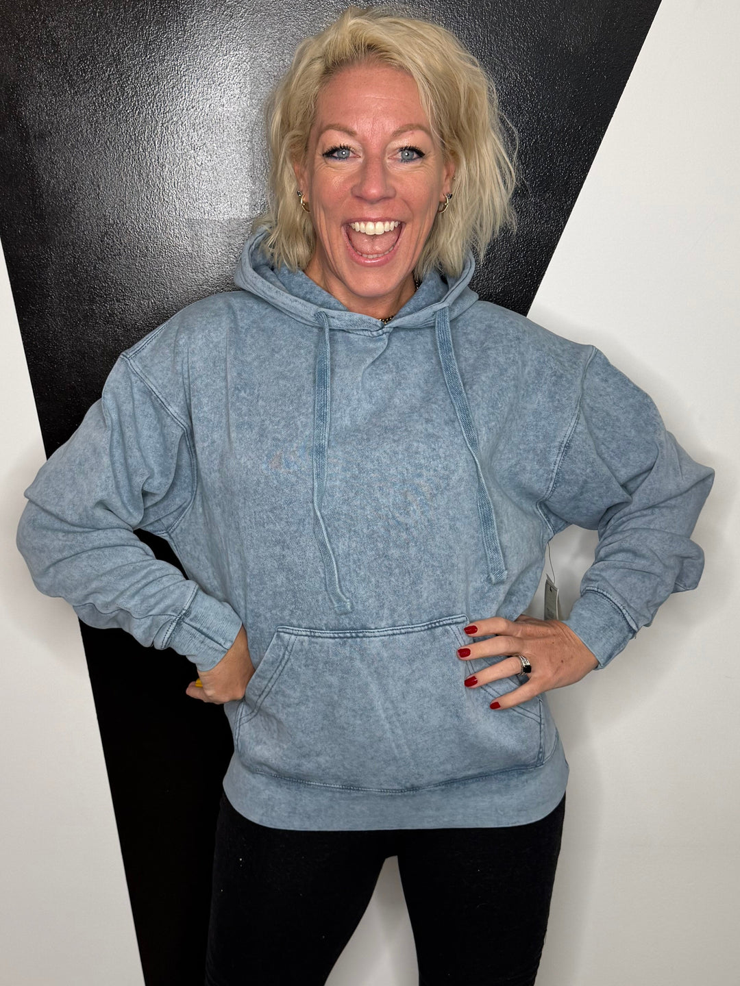 Person standing on a black and white floor with a minimal background