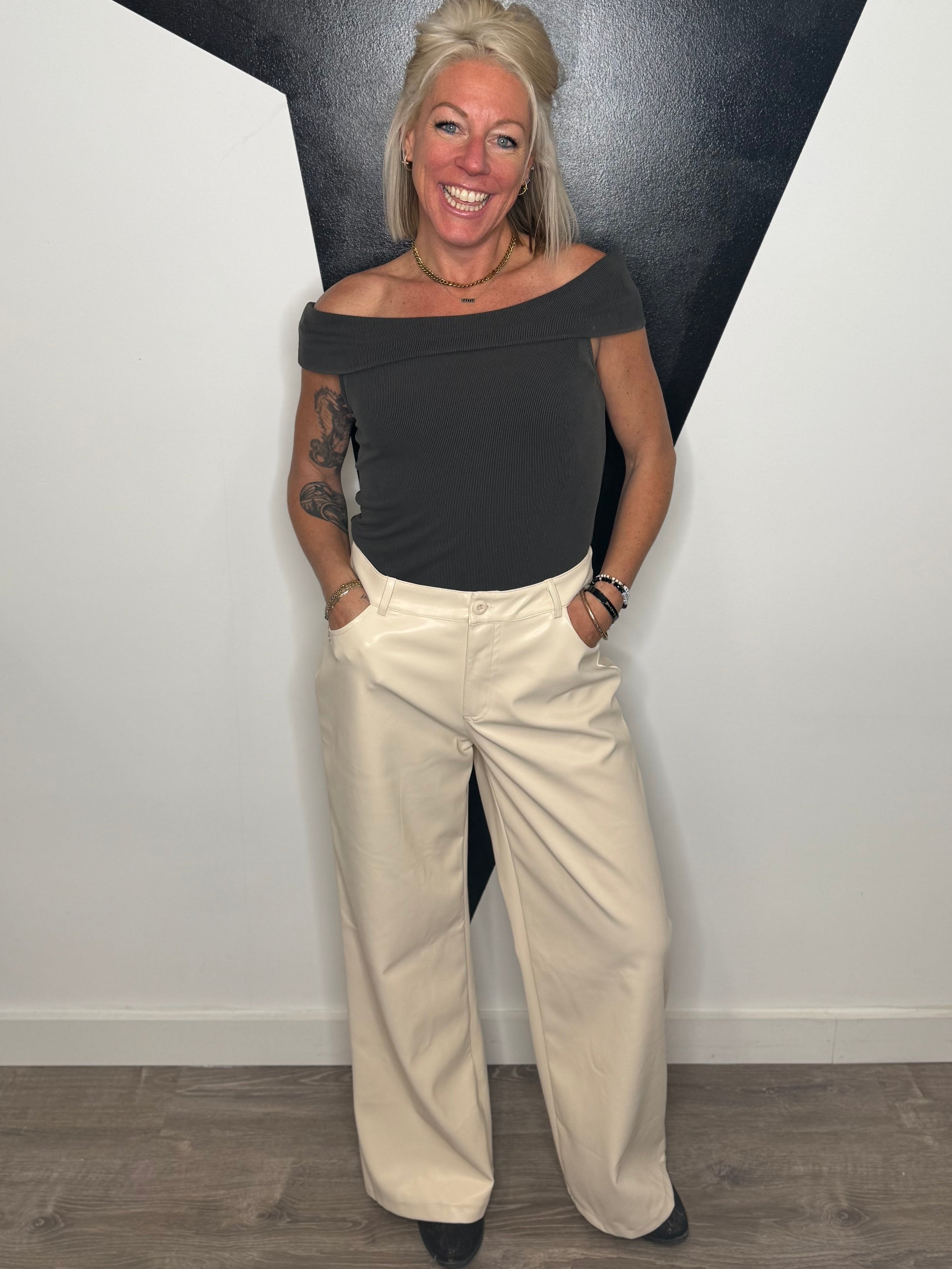 Woman standing against a black and white geometric wall