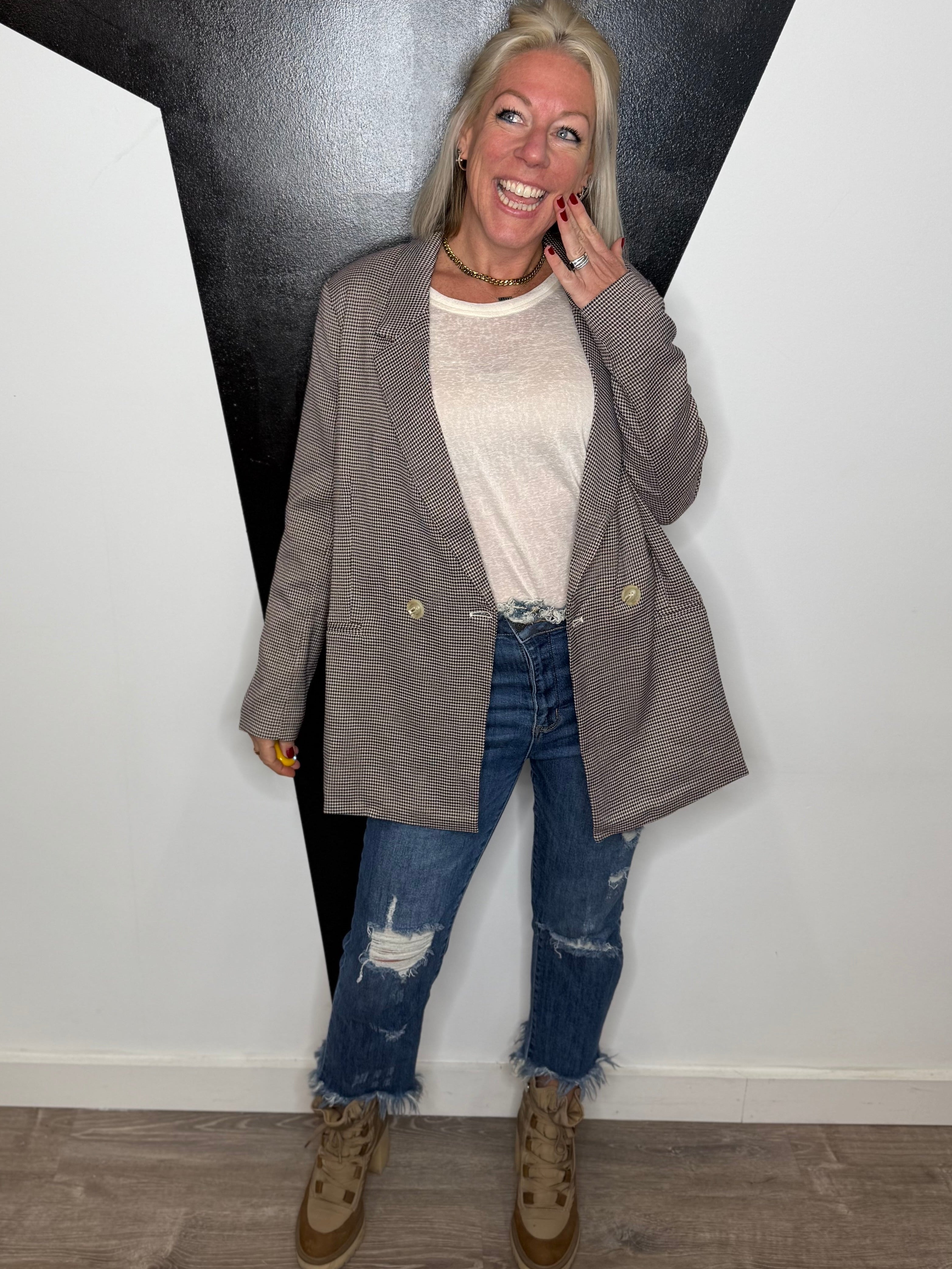 Woman standing in a room with geometric wall design