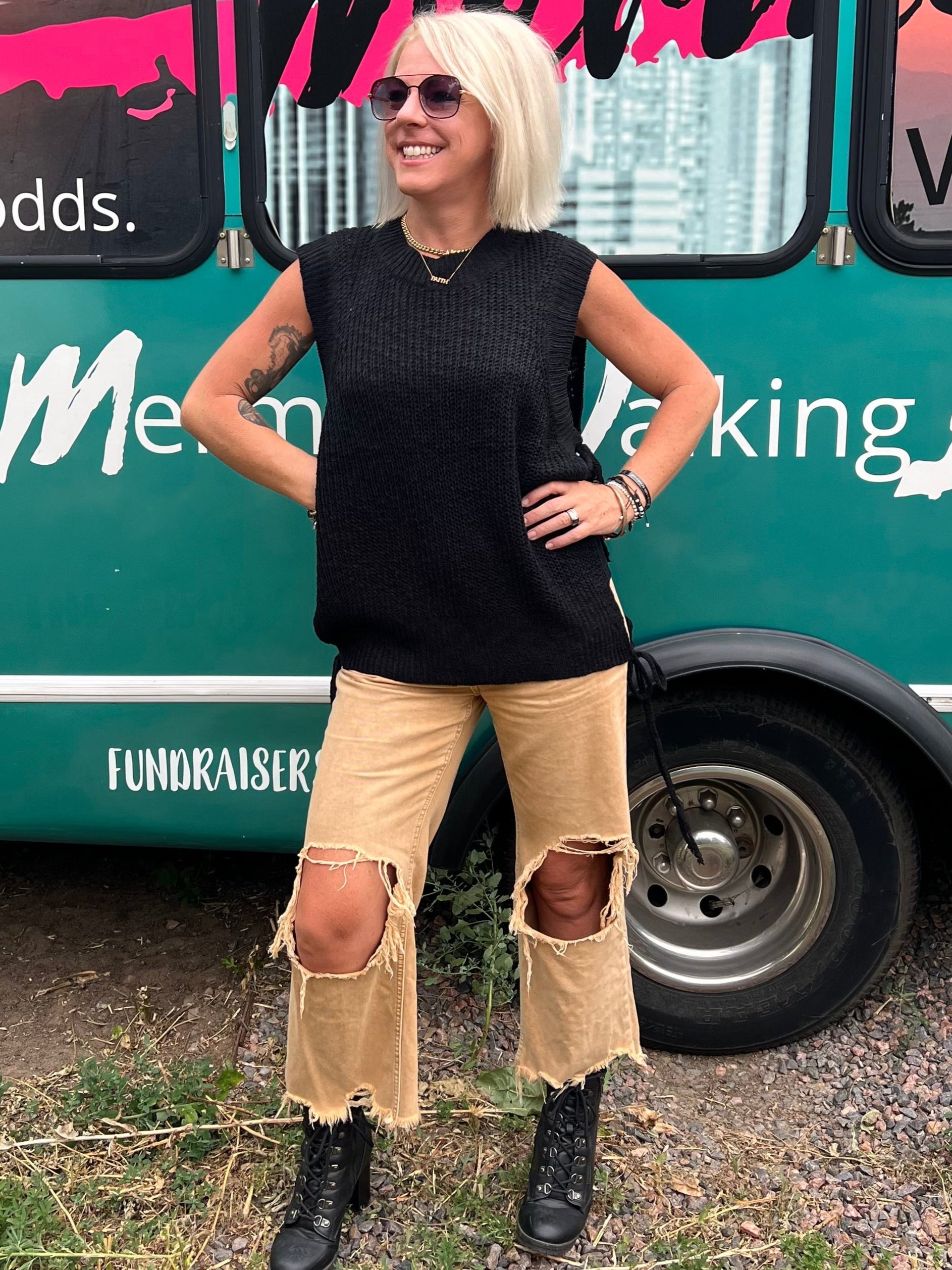 Woman standing in front of a teal fashion truck.