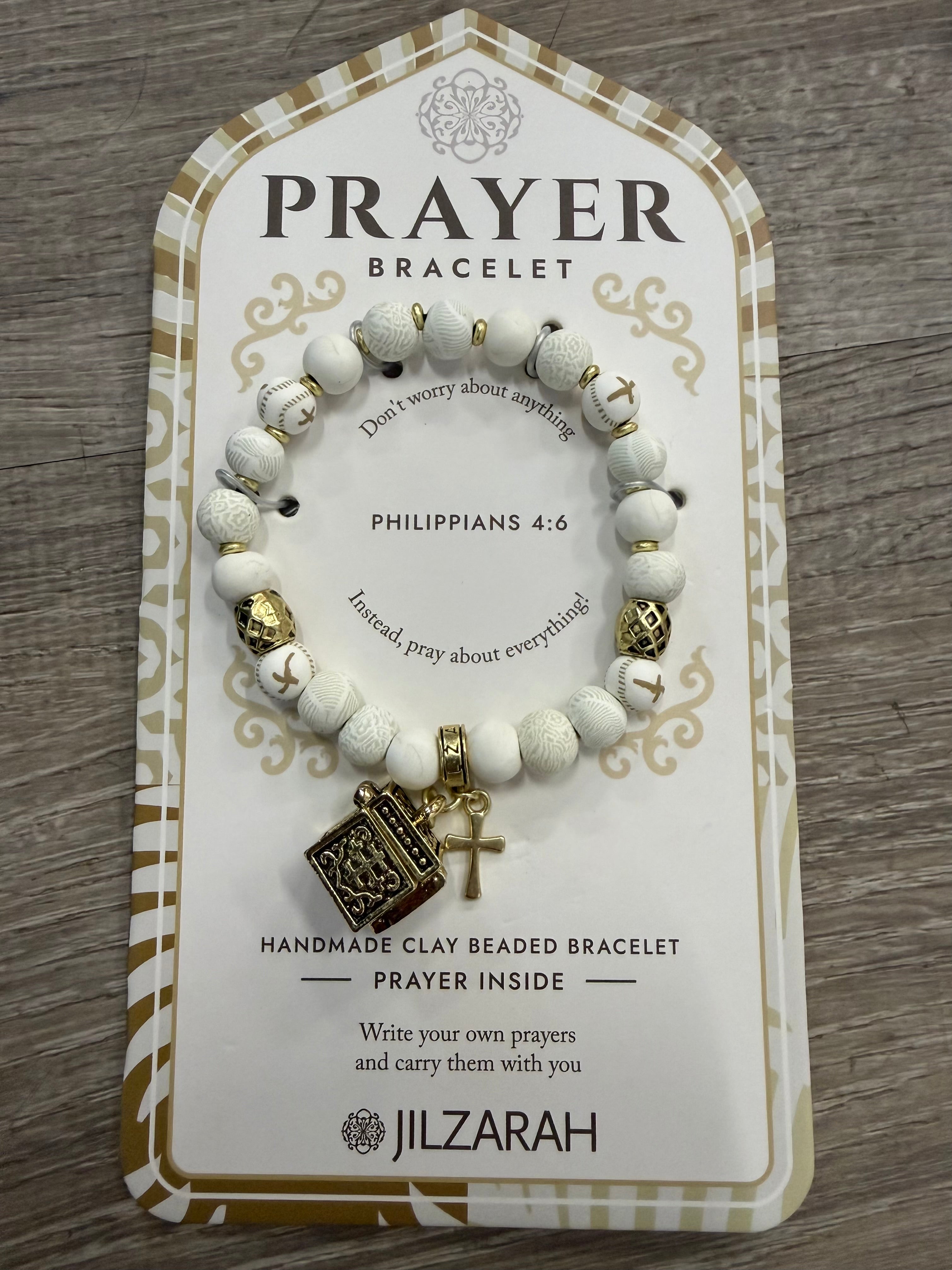 Prayer bracelet on a branded card with text.